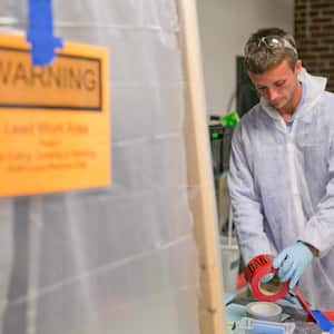 worker handling lead paint risk